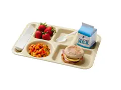 A beige cafeteria tray holding strawberries, diced sweet potatoes and peppers, a ham, egg and cheese English muffin sandwich, a carton of fat-free milk, a napkin and a plastic spork